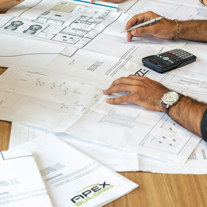 shed quotes and construction notes on a table